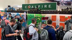 coalfire written on a street sign in front of a group of people looking at a wall of graffiti